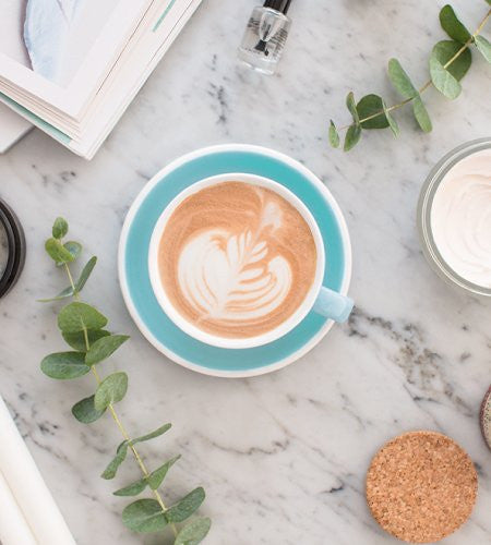 Lavazza Crema E Gusto K-Cup Pods, Medium Roast Coffee, Full-Bodied, 621g/21.9 oz on a marble tray with eucalyptus branches